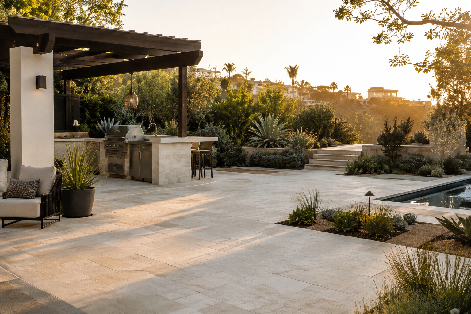 Illustrative Southern California outdoor-living concept with pavers, planting, pergola and kitchen
